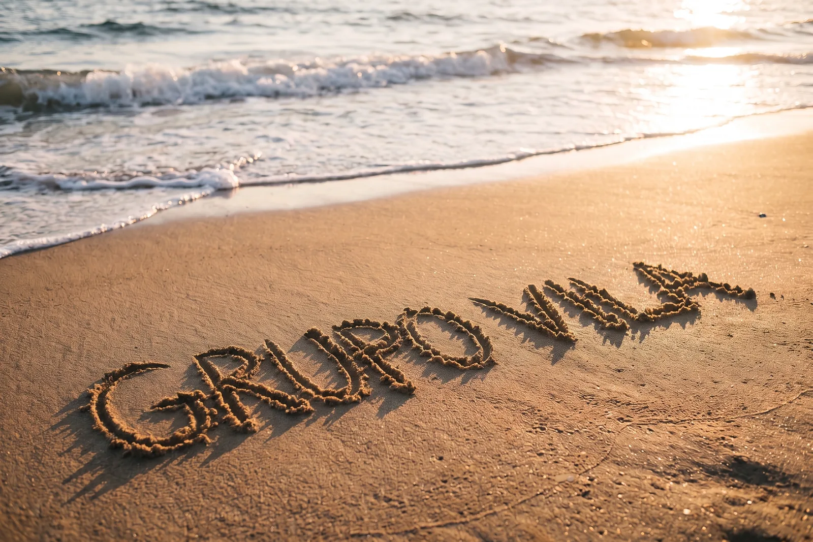 The same beach with the company name GRUPO VILA written in the sand